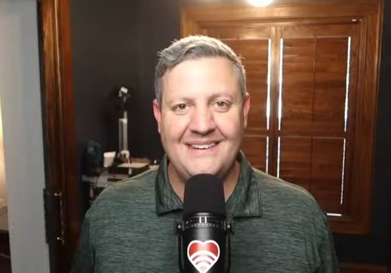Drew behind the Waves podcast microphone